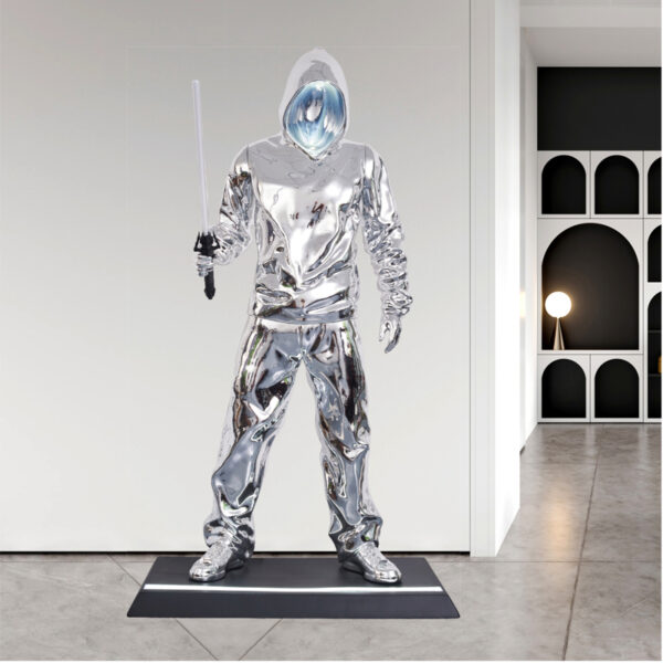 Chrome resin sculpture lamp of a futuristic hooded figure holding LED sword